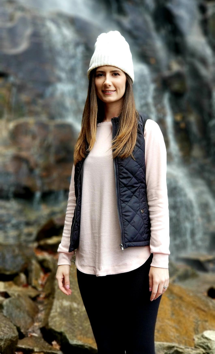 A reviewer models the vest in classic black.