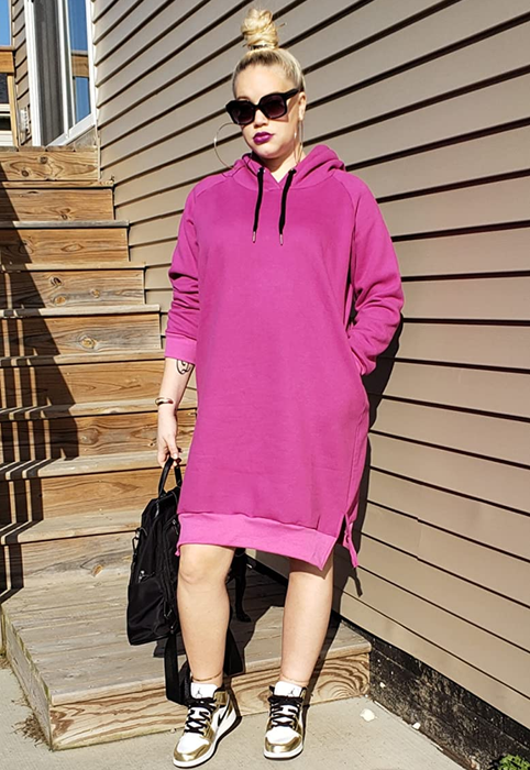 The reviewer is styled in the pink hoodie dress with sneakers.