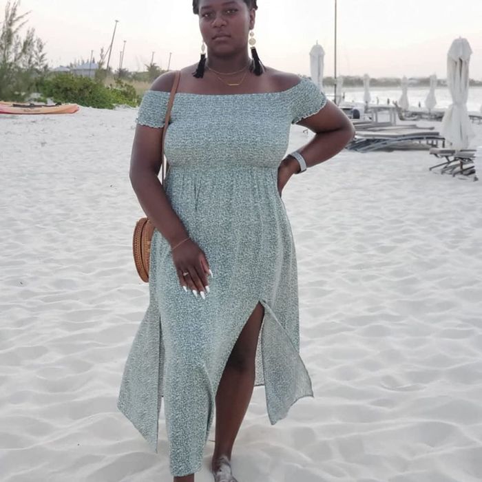 Reviewer wearing the light green version of the dress