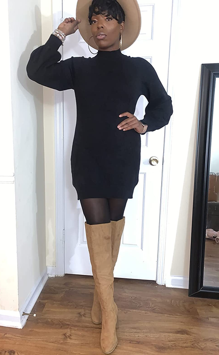 The reviewer is wearing the black dress paired with tights and tan boots.