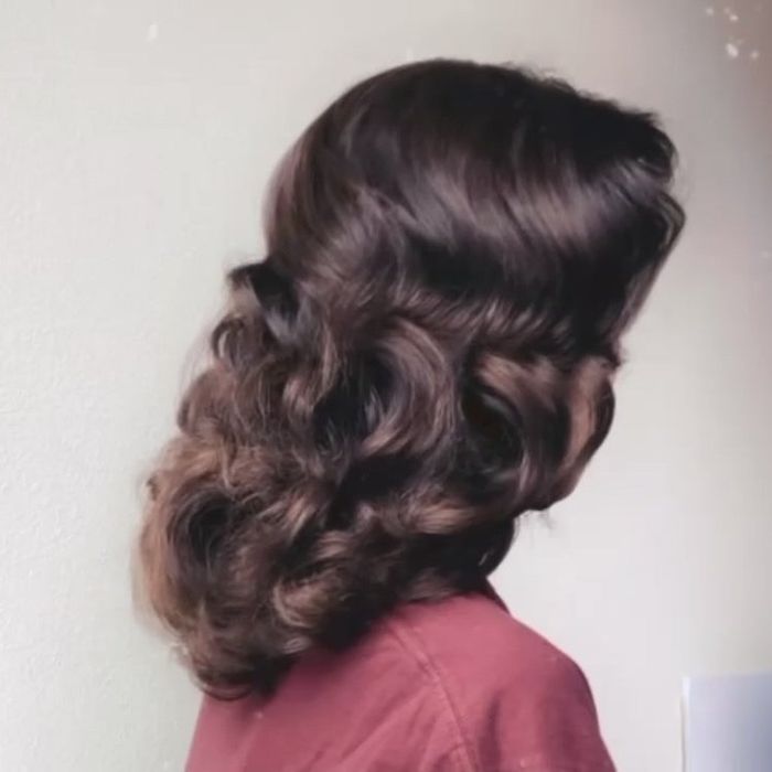 The same reviewer showing the finished look, with vintage-inspired shiny, brushed-out curls