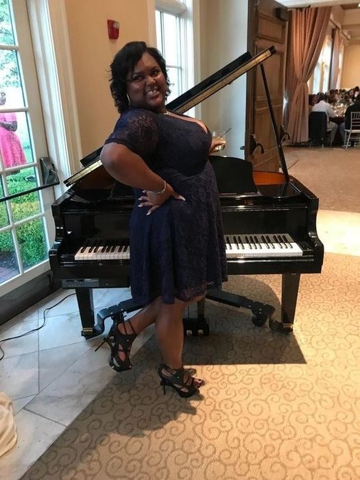 A reviewer wearing the same dress in a deep blue shade with black heels