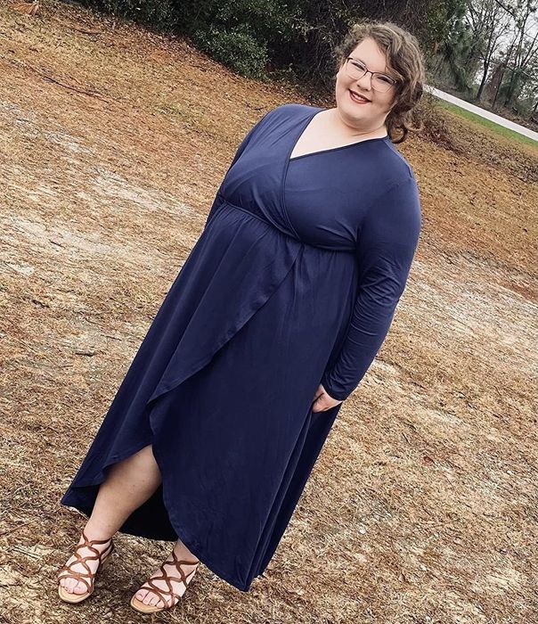 Reviewer showcasing the dark blue dress.