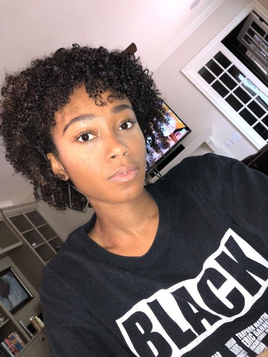 A reviewer displaying well-moisturized coils