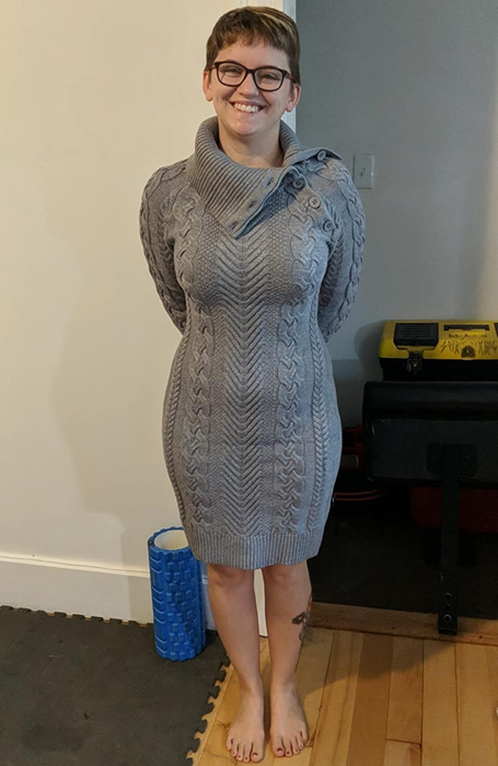 The reviewer is wearing the gray dress.