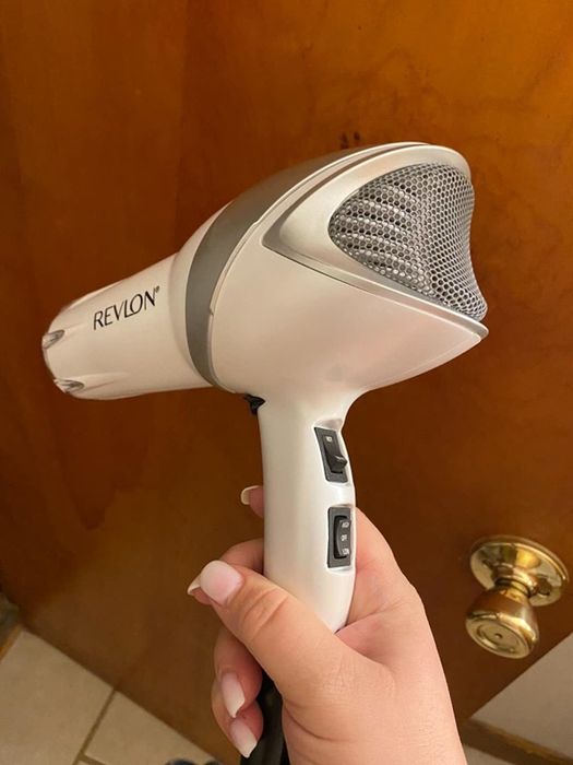 Reviewer holding the Revlon hair dryer