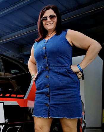A reviewer in a blue mini dress
