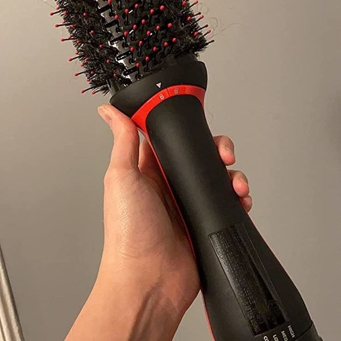 Reviewer holding the dryer brush
