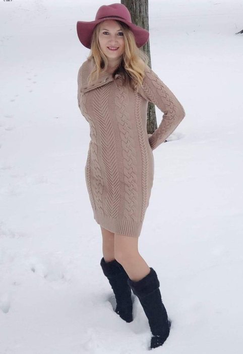 The reviewer is styled in the tan dress with black boots, braving the snow.