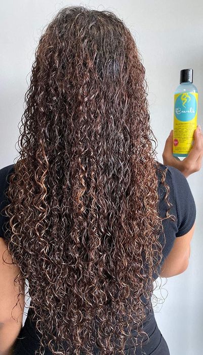 Model displaying her shiny, long curls.