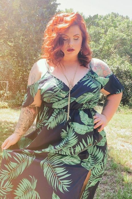 A reviewer wearing the leaf print dress