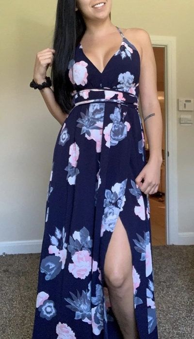 A reviewer wearing a beautiful floral maxi dress