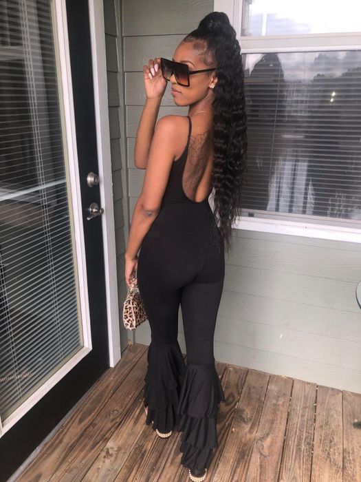 A reviewer with a long ponytail styled in soft waves