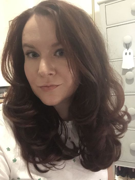 The writer showcasing sleek straightened hair with bouncy curled ends