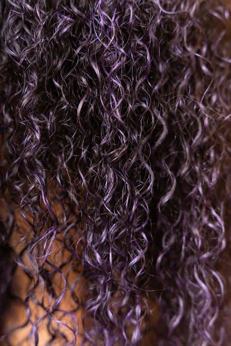 Curly hair styled with the purple hair color gel.