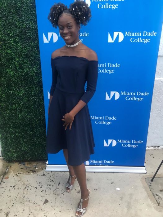 A reviewer wearing the dress in blue