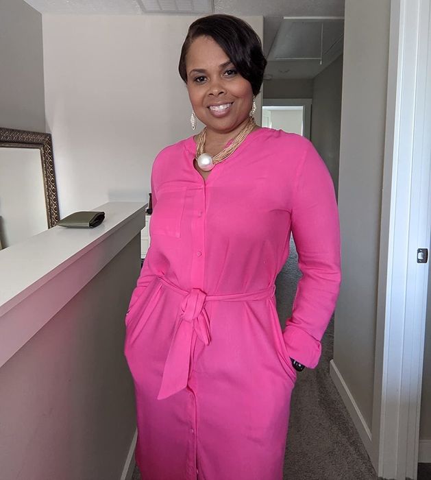 A reviewer wearing the pink dress