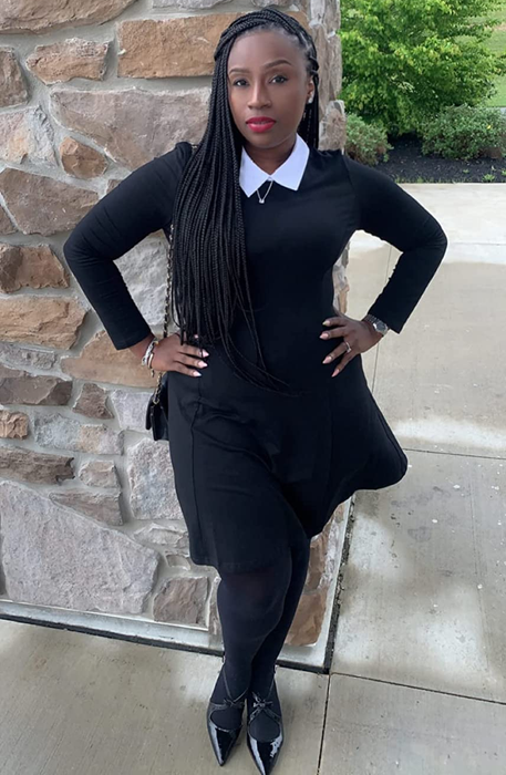 reviewer styling the black dress with black tights and heels