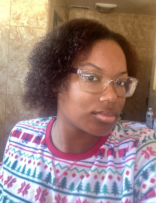 Reviewer with short, coily hair