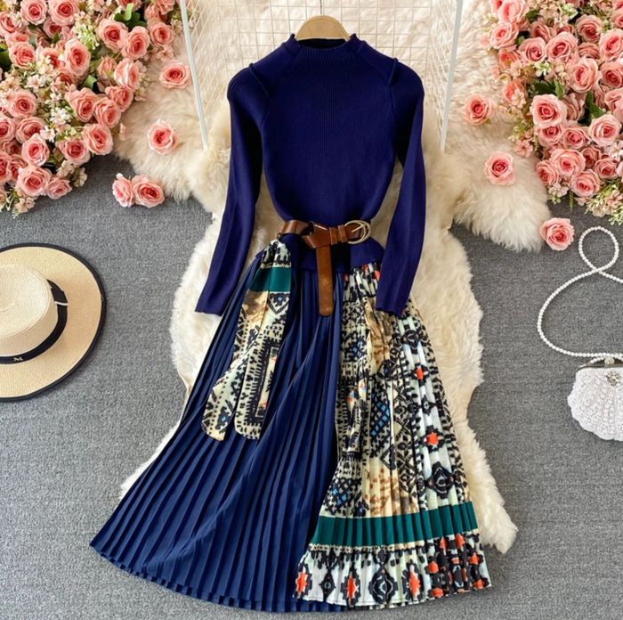 The blue dress is styled with a brown waist belt, adding a chic touch.