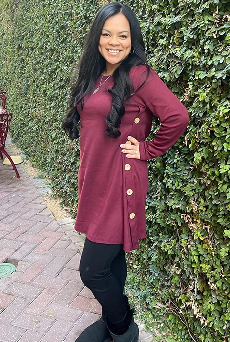 reviewer sporting the burgundy dress with black leggings and shoes