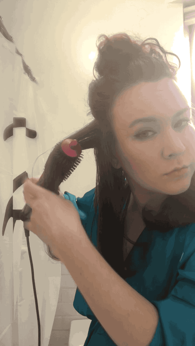A gif showing the writer using the Airwrap's straightening brush.