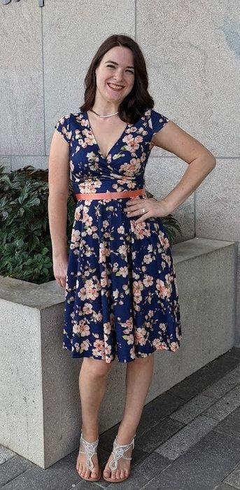 a reviewer wearing the navy floral dress