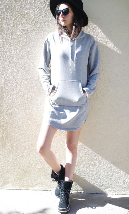 A reviewer showcasing the dress in grey