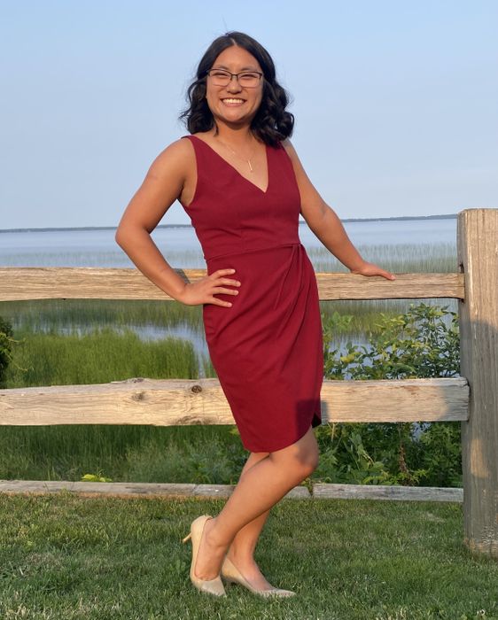 a reviewer wearing the red version of the dress