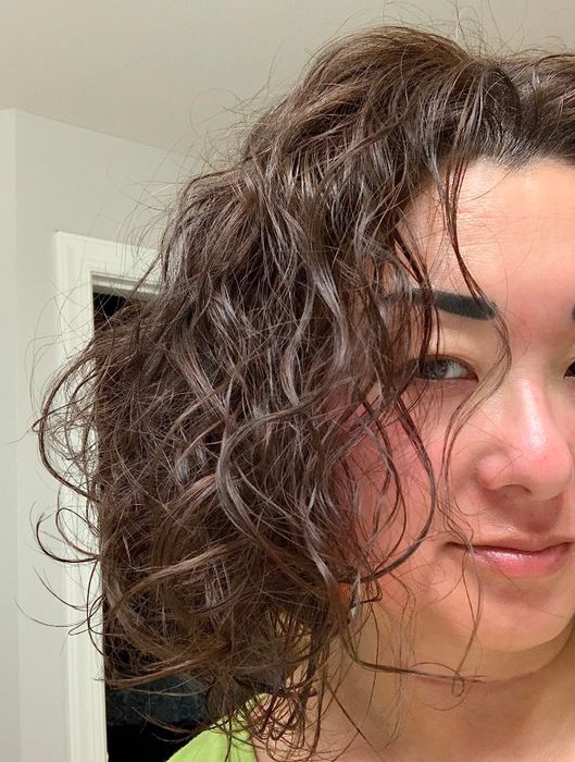 The reviewer’s curly hair enhanced by the blow dryer