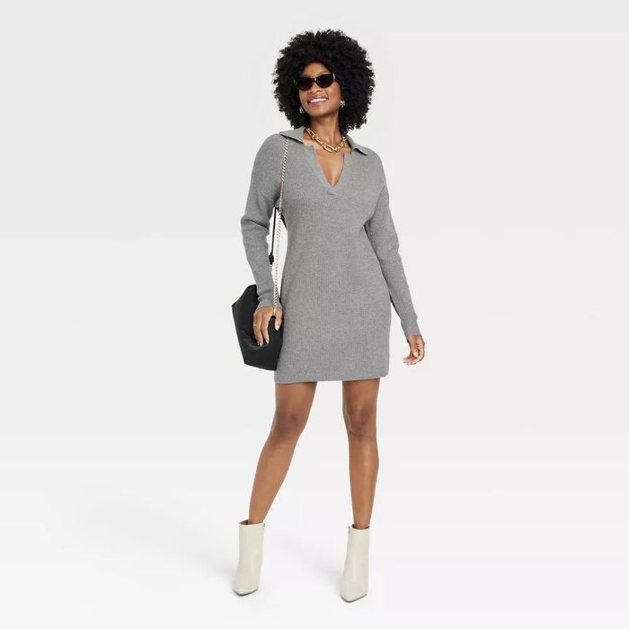 model wearing the gray dress with white boots