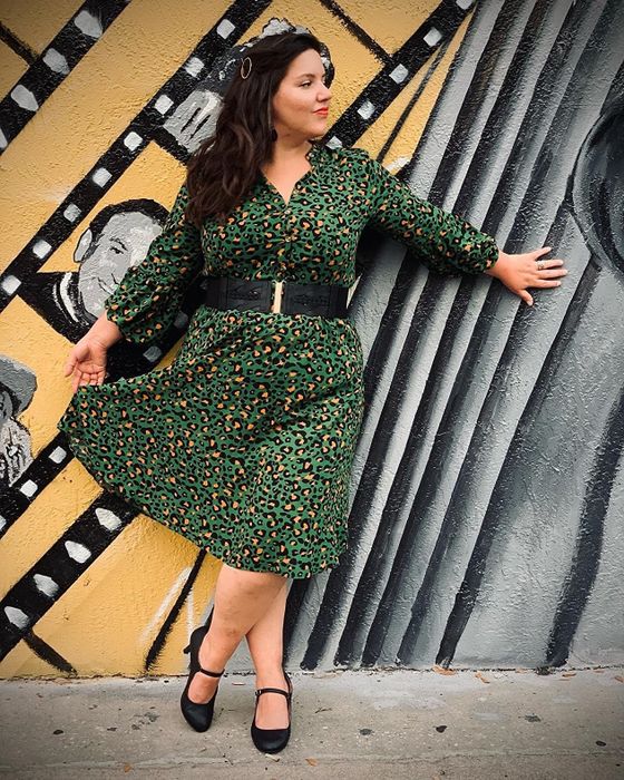 Reviewer wearing the green leopard-print version of the dress