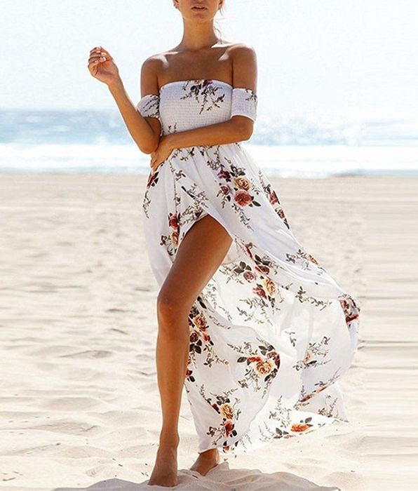 A model wearing the off-the-shoulder dress on the beach.