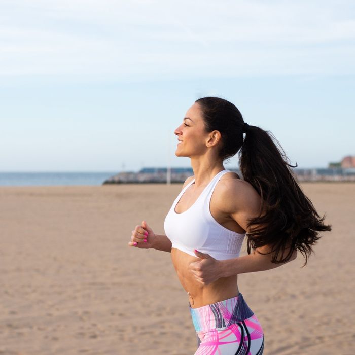 A model with thick, long hair styled in a ponytail using the hair tie