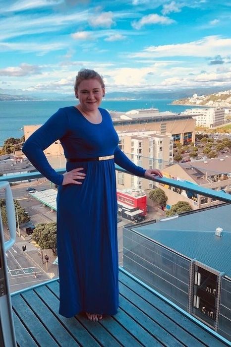 A reviewer in the long-sleeve blue maxi dress.