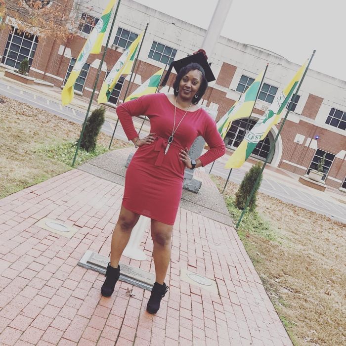 A reviewer wearing the dress in red