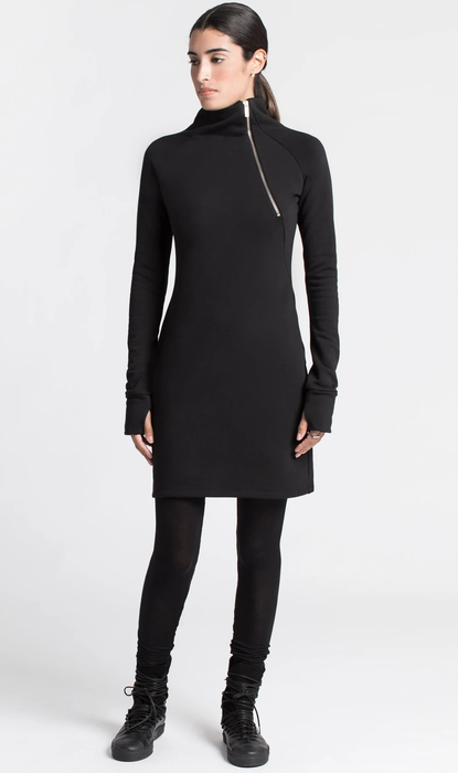 model styling the black dress with black tights and shoes