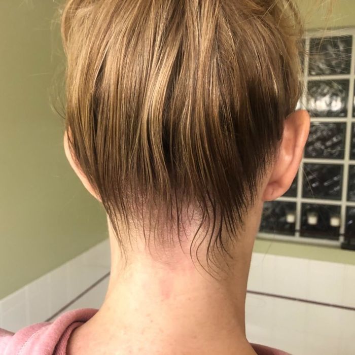 The same reviewer with a neat, slicked-back bun after using the hair-finishing stick