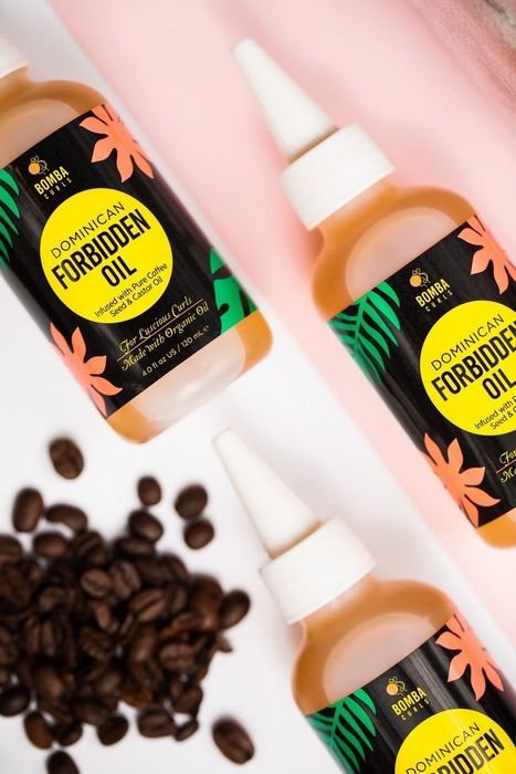 Bottles of the forbidden oil placed next to coffee beans