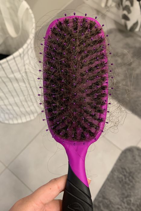 Writer’s hairbrush loaded with a tangled mess of hair