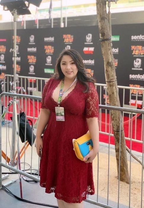 A reviewer in the dress in red