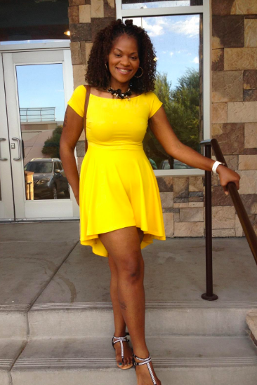 A reviewer wears the dress in a bright yellow shade.