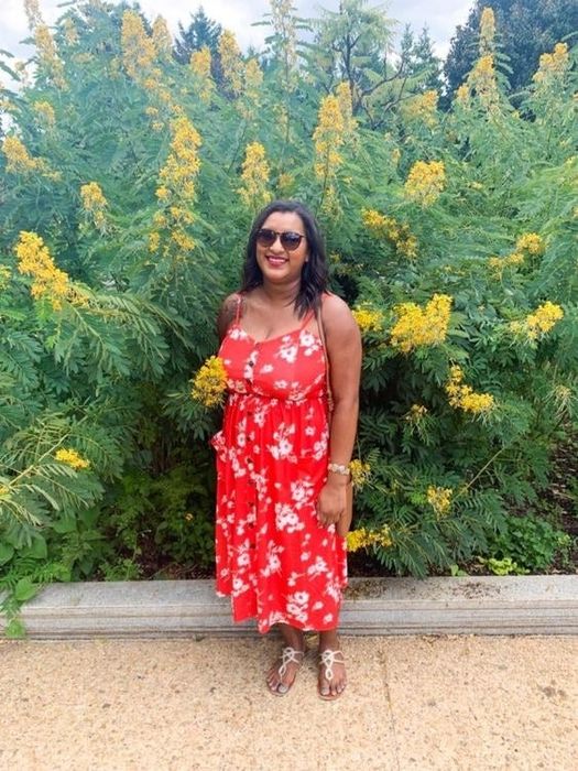 A reviewer rocking a sunflower print dress