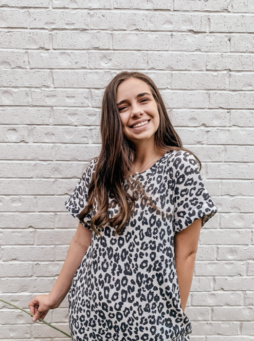 A reviewer models the leopard print version of the short sleeve dress.