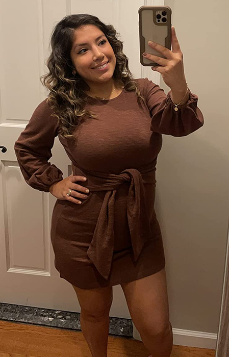 The reviewer is wearing a brown dress, showcasing its elegant simplicity.