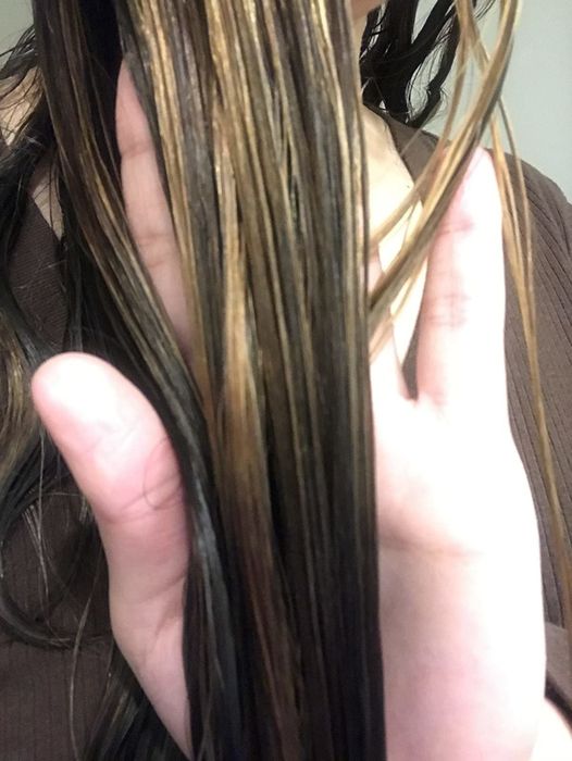 A reviewer's photo showing their hair after using the detangling spray.