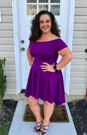 A reviewer models the above-the-knee dress in purple.