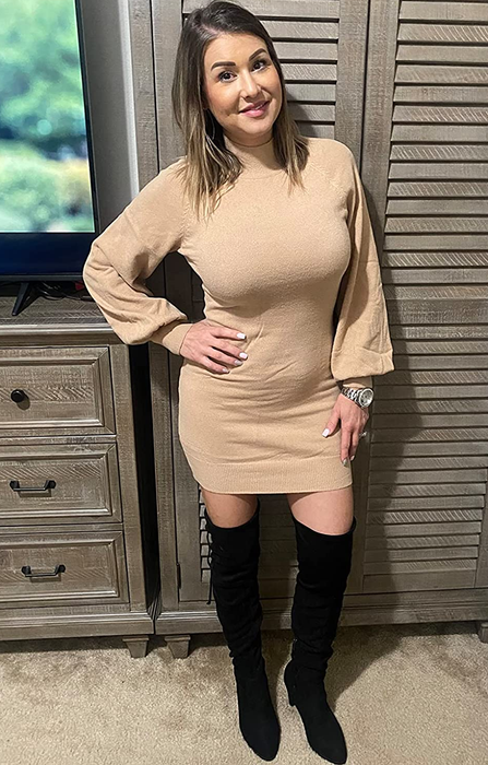 The reviewer is styled in the beige dress with black boots.