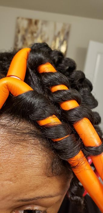 Reviewer with their hair wrapped around curling rods