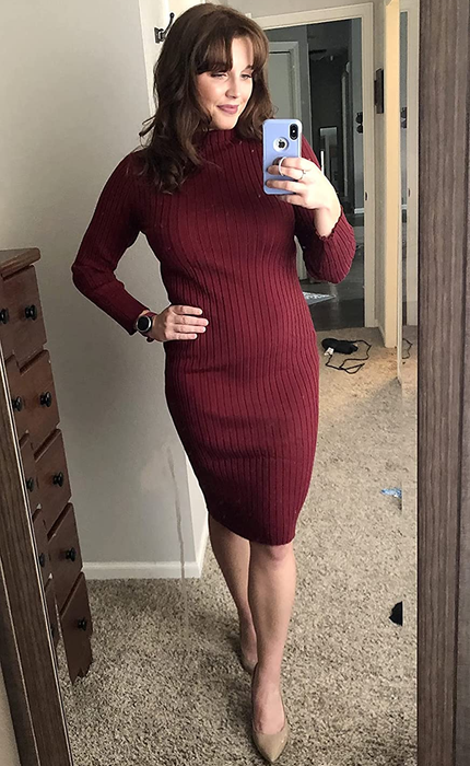 The reviewer is sporting a burgundy dress with tan heels.